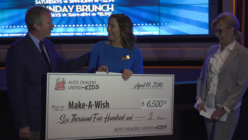 Co-Chairs John Yark (Yark Automotive) and Marianne Ballas (Ballas Buick GMC) present a check to Make-A-Wish 